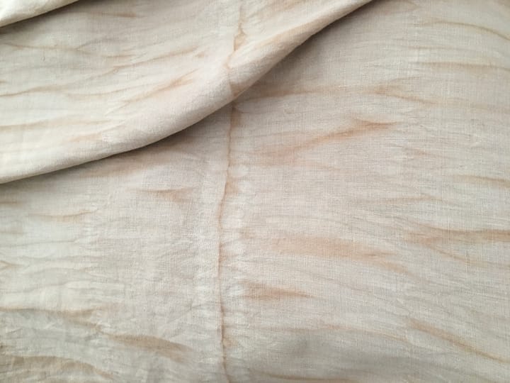 beige fabric with organic patterns of wavy reddish brown